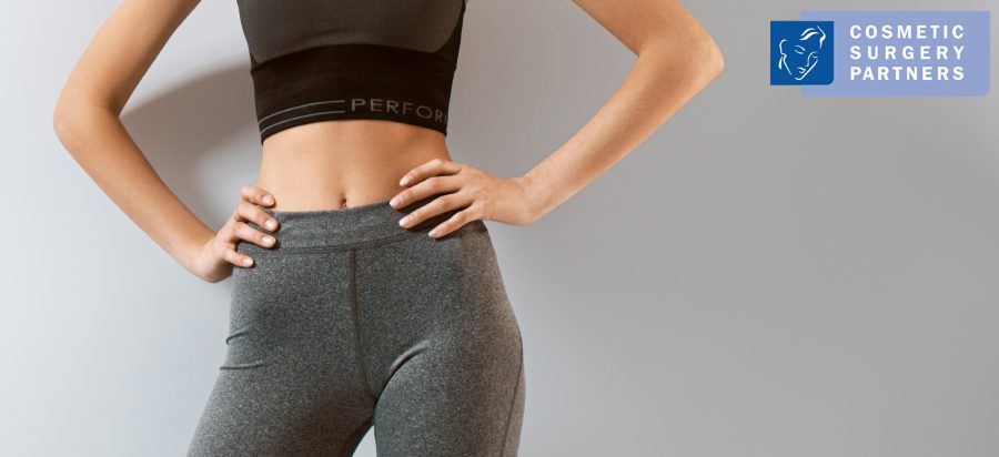 Woman wearing fitted activewear, shown from waist to thigh, used to illustrate discussions around physical comfort and clothing fit